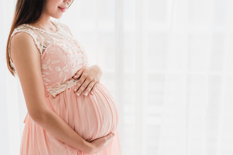 happy-beautiful-pregnant-woman-holding-pregnant-belly